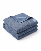 Folded blue cooling blanket with satin trim, studio shot on white
