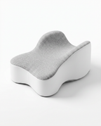 Grey memory foam knee pillow, three-quarter angle on white