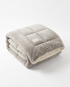 Light gray color variant of the plush winter comforter, folded studio shot