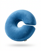 Blue velvet C-shaped lap support pillow shown upright on white background