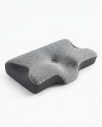 Grey quilted contoured cervical memory foam pillow on white, angled view
