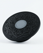 Black wobble balance board with grey center medallion, angled studio shot