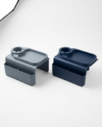 Grey and navy blue couch arm organizer trays side by side on white