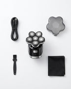 Flat-lay of the 7D shaver kit with cable, cap, cleaning brush and cloth