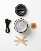 Flat-lay of the wax warmer kit with lid, cord, wax beads and applicator sticks