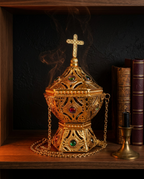 Gold incense burner smoking on a wood altar shelf beside antique books