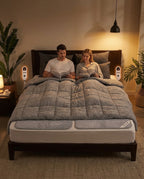 Couple reading in bed with dual-zone heated pads and separate controllers