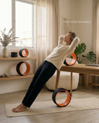 Woman stretching her back over the large orange roller on an office break