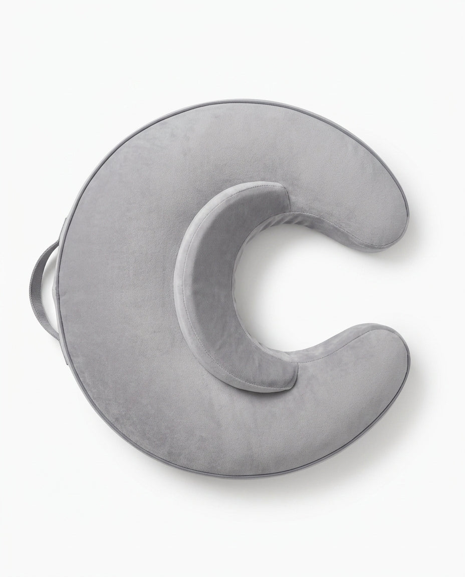 Overhead view of the grey C-shaped feeding pillow showing its arch