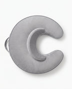 Overhead view of the grey C-shaped feeding pillow showing its arch