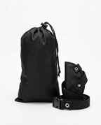 Foot hammock folded compact beside its black drawstring travel pouch