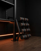 Bench folded and stored upright against a wall showing its compact footprint