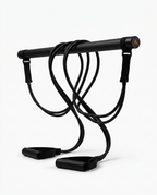 Black Pilates bar kit with coiled resistance bands standing upright