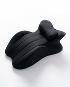 All-black contoured cervical neck support pillow on white background