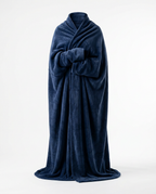 Person wrapped in a navy blue wearable blanket, studio shot