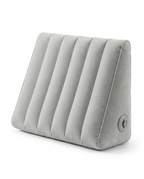 Grey inflatable wedge support pillow on white, side angle view