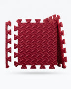 Red EVA foam puzzle exercise mat tiles with interlocking edges on white