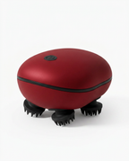 Red electric scalp massager with black silicone claws on white background