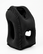 Black inflatable travel neck pillow standing upright on white background