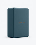 Teal blue EVA foam yoga block with embossed logo, studio shot on white