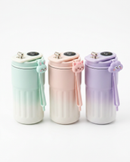 Three ombre coffee mugs in mint, pink and purple with cartoon lid straps