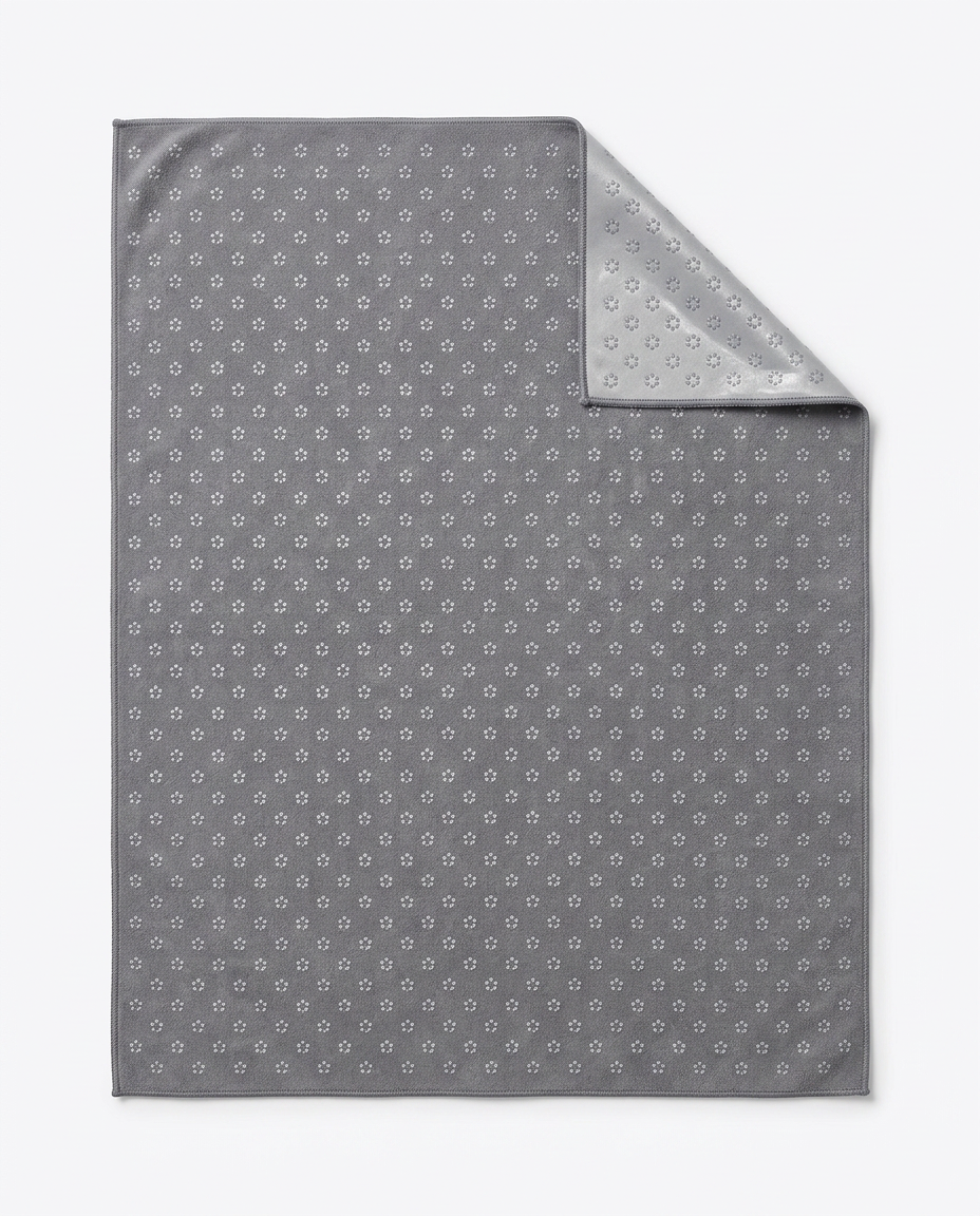 Gray yoga towel showing silicone grip-dot pattern with corner folded