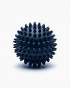 Navy blue spiky recovery massage ball, studio packshot on white