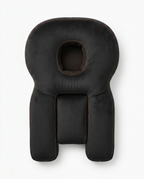 Top-down view of the black face-down support pillow showing its full shape