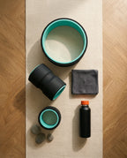 Flat-lay of the three teal back rollers with towel and water bottle on a mat