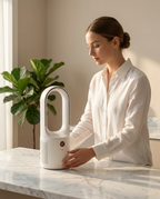 Woman placing the compact white tower fan on a marble table by a plant