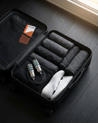 Compact shoe dryers packed with clothes and sneakers in a carry-on suitcase