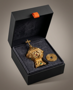 Gold censer and coiled chain nestled in a black velvet gift box