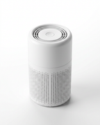 Three-quarter view of the white desktop air purifier with top vents and mesh