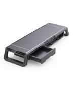 Rear view of the grey monitor stand showing USB ports and pulled-out drawer