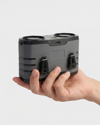 Hand holding the palm-sized cooling unit to show its compact scale