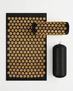 Gold-spike acupressure mat, pillow and carry bag on a white background