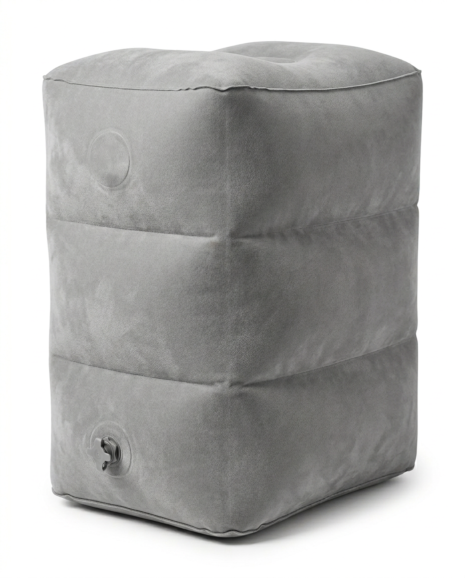 Light grey inflatable travel footrest pillow, studio shot on white background