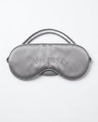 Grey silk sleeping eye mask with embroidered Pyre Fit logo, on white