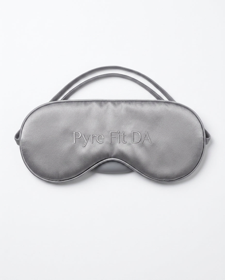 Grey silk sleeping eye mask with embroidered Pyre Fit logo, on white
