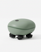 Sage green electric scalp massager with black silicone claws on white