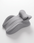 All-grey contoured cervical neck support pillow on white background