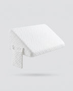 White quilted wedge pillow with detachable extension panel, floating on grey