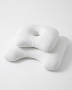 White ergonomic side-sleeper pillow with ear cutout and ribbed texture, studio shot