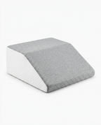 Leg elevation wedge with grey quilted top and white sides, angled view