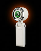 White portable handheld fan with lit digital display on dark orange-glow backdrop