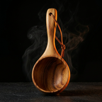Wooden sauna ladle standing upright with steam rising on a dark backdrop
