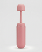 Pink portable bidet bottle with rounded leak-resistant cap fitted on top
