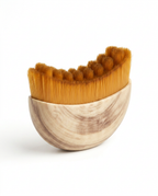 Small wooden facial comb packshot with bristles, on white