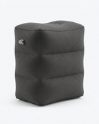 Deep grey inflatable travel footrest pillow, studio shot on white background