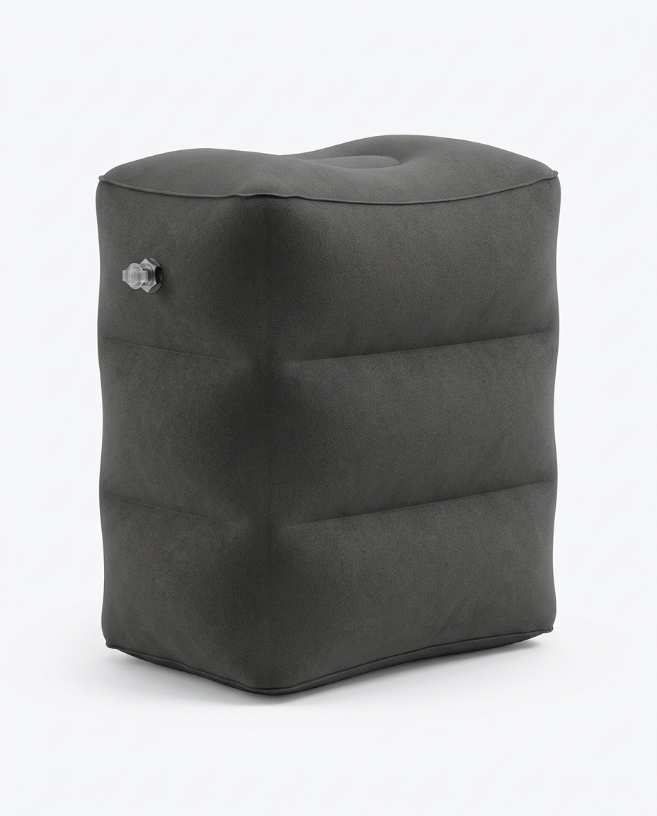 Deep grey inflatable travel footrest pillow, studio shot on white background